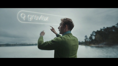 a man standing in front of a body of water