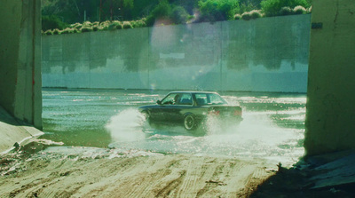 a car is driving through a flooded street