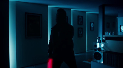 a person holding a red object in a dark room