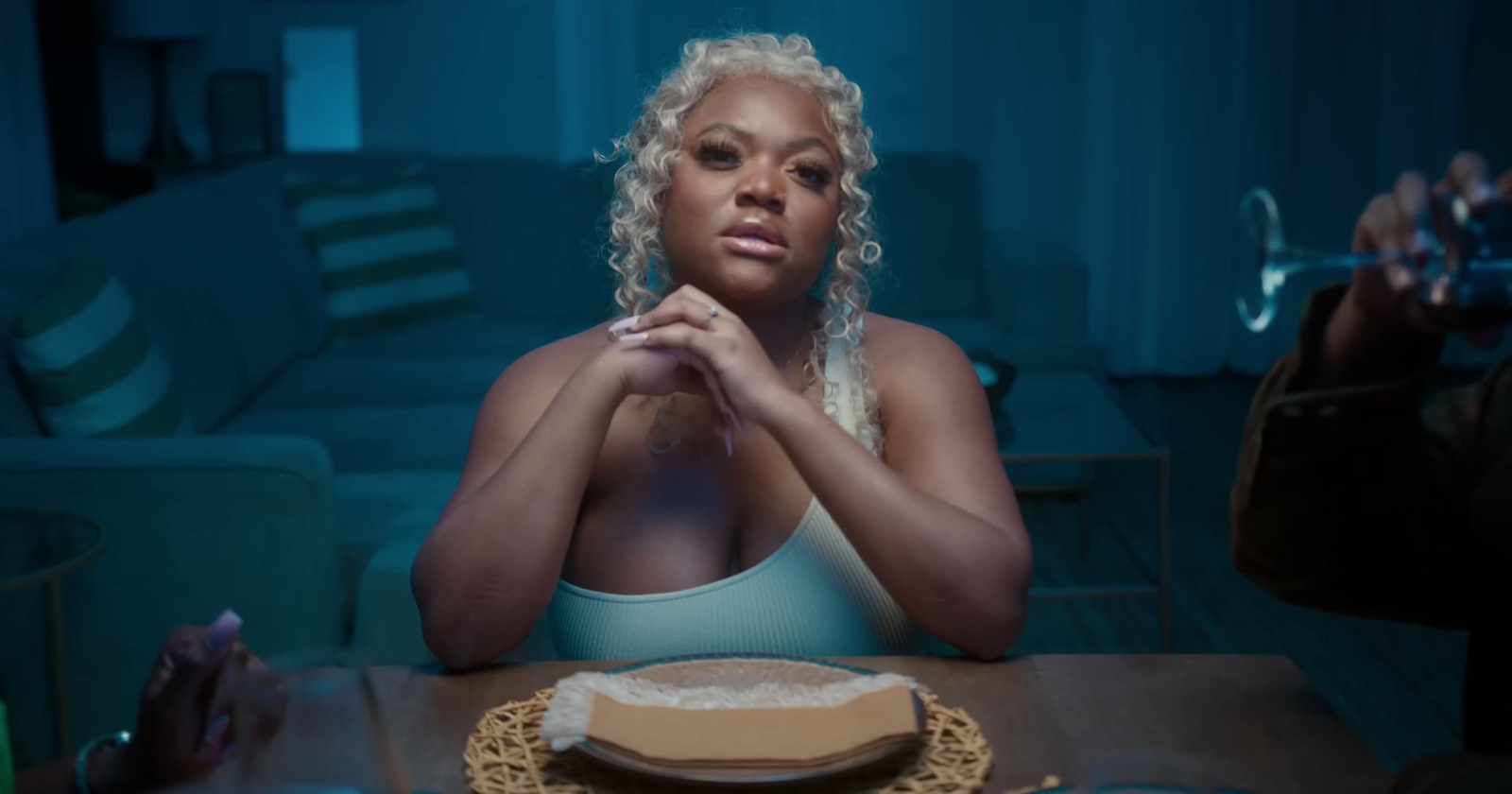 a woman sitting at a table with a plate of food