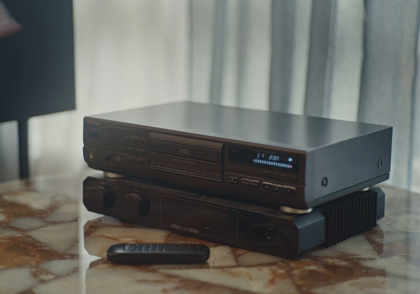 a pair of stereos sitting on top of each other on a table