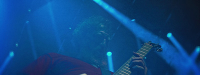 a man playing a guitar on stage at a concert