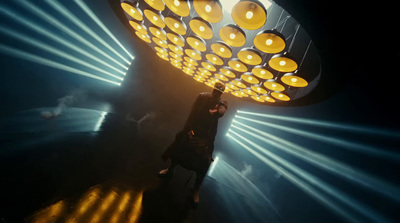 a person standing in front of a large light fixture