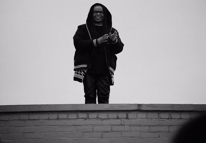 a person standing on top of a brick wall