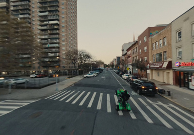 a person riding a scooter on a city street