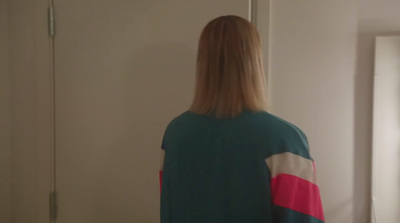 a woman standing in front of a mirror in a room