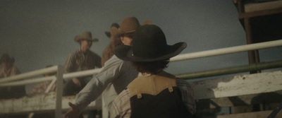 a group of men standing next to each other near a fence