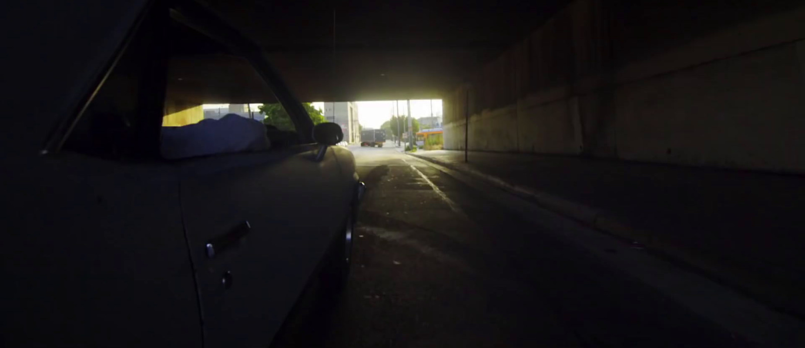 a car driving through a tunnel at night