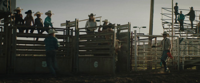 a group of men standing on top of a wooden fence