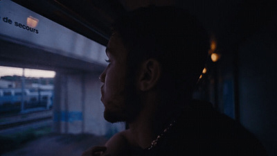 a man looking out the window of a train