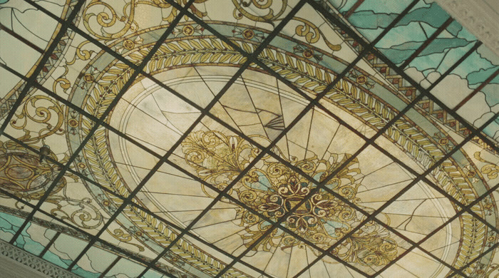 the ceiling of a building with a decorative glass design