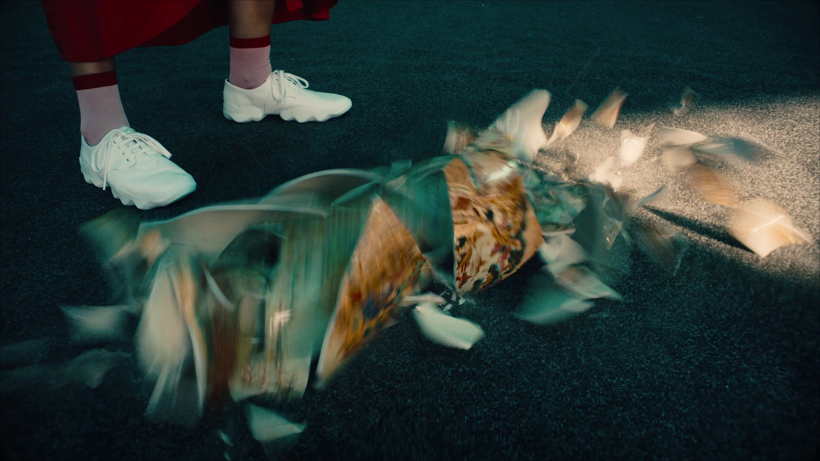 a person standing over a pile of trash on the ground