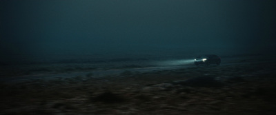 a car driving down a road at night