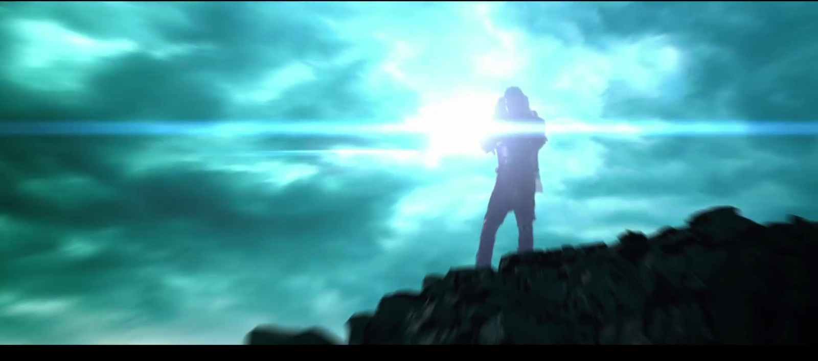 a person standing on top of a mountain under a cloudy sky