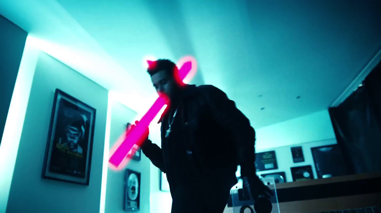 a man standing in a room with a neon stick in his hand