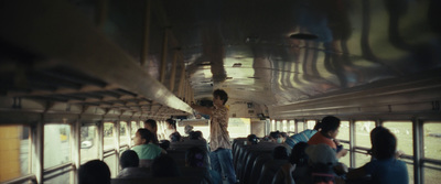 a group of people riding on top of a bus