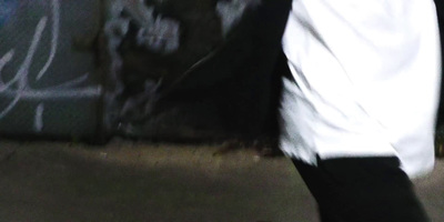 a skateboarder in a white shirt and black pants