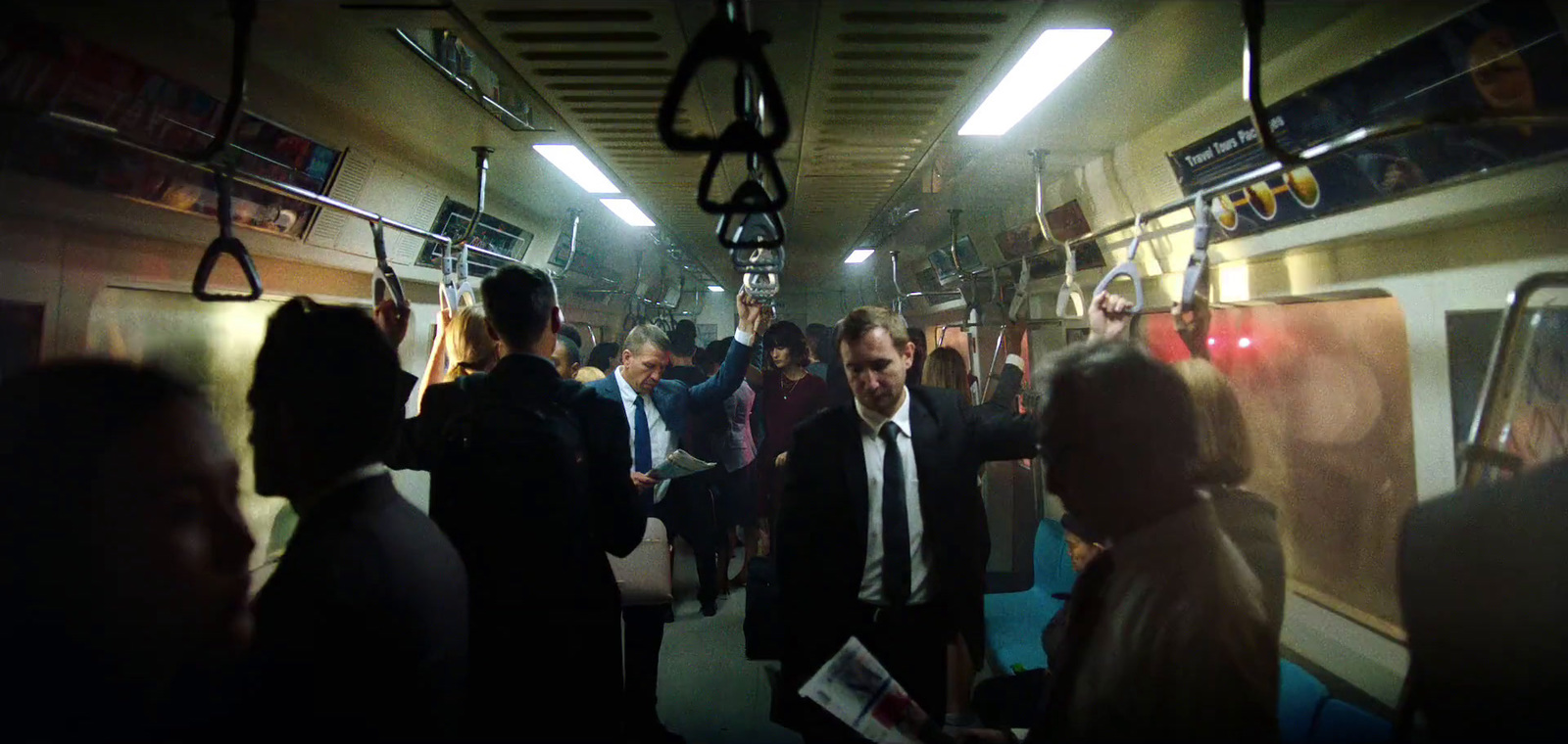 a group of people standing in a subway car