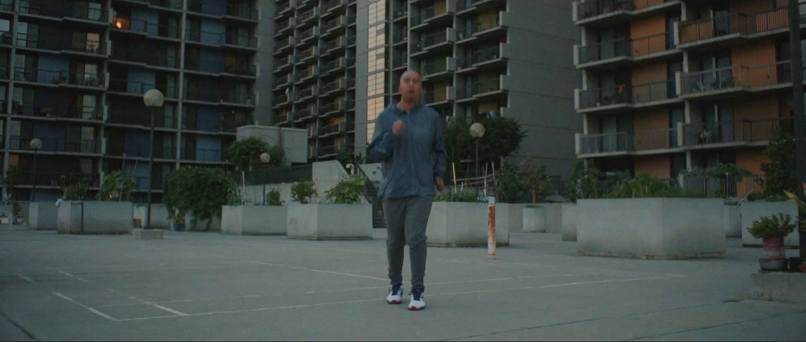 a man standing on top of a tennis court holding a racquet