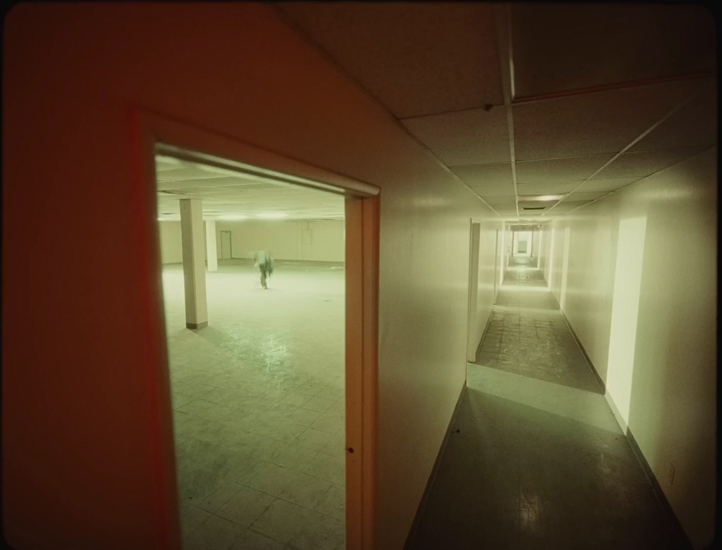 a person walking down a hallway in a building