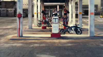 a group of people standing around a gas station