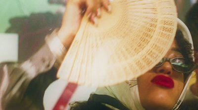 a woman with a large fan on her head