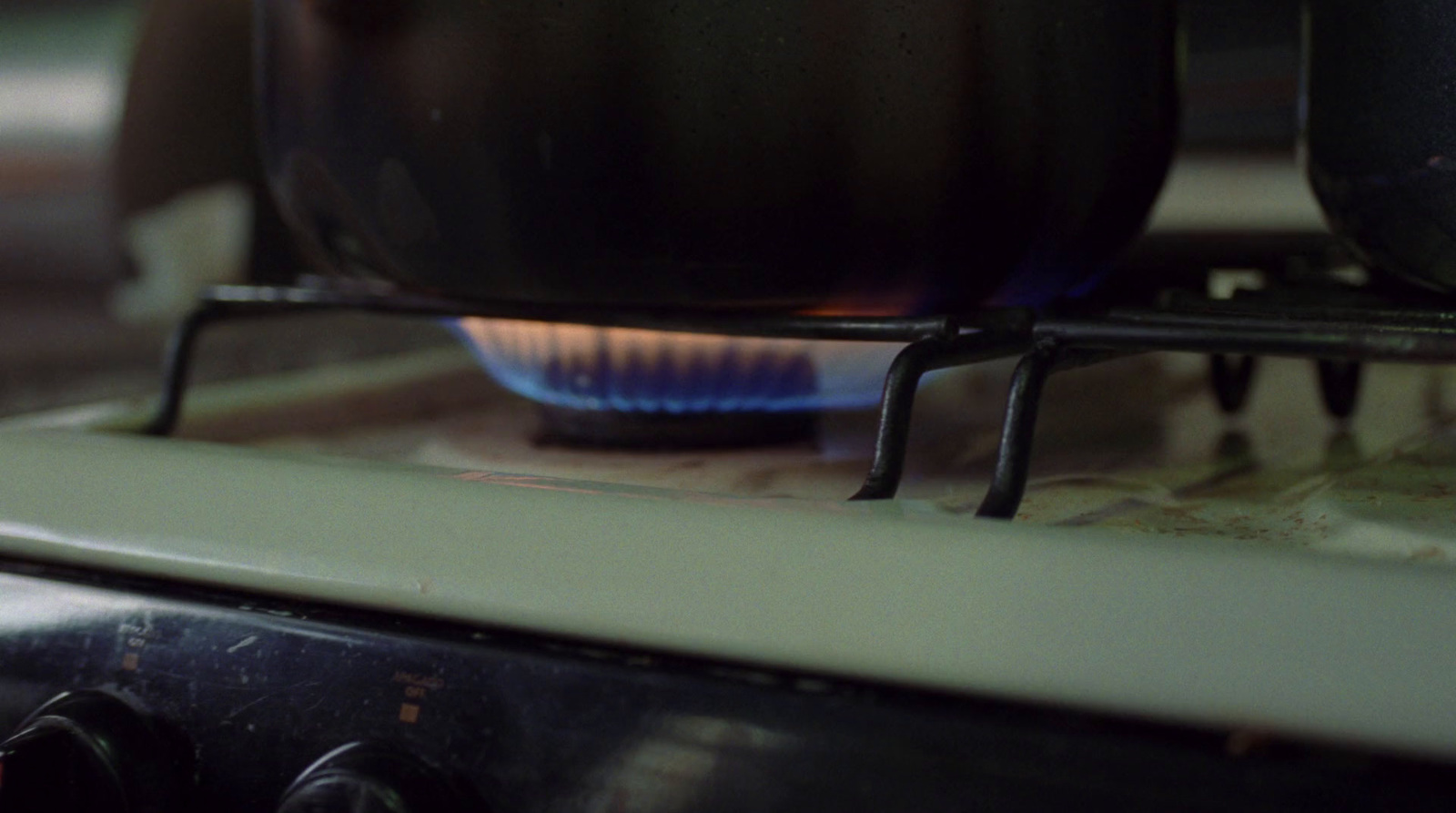 a close up of a stove top with a blue flame