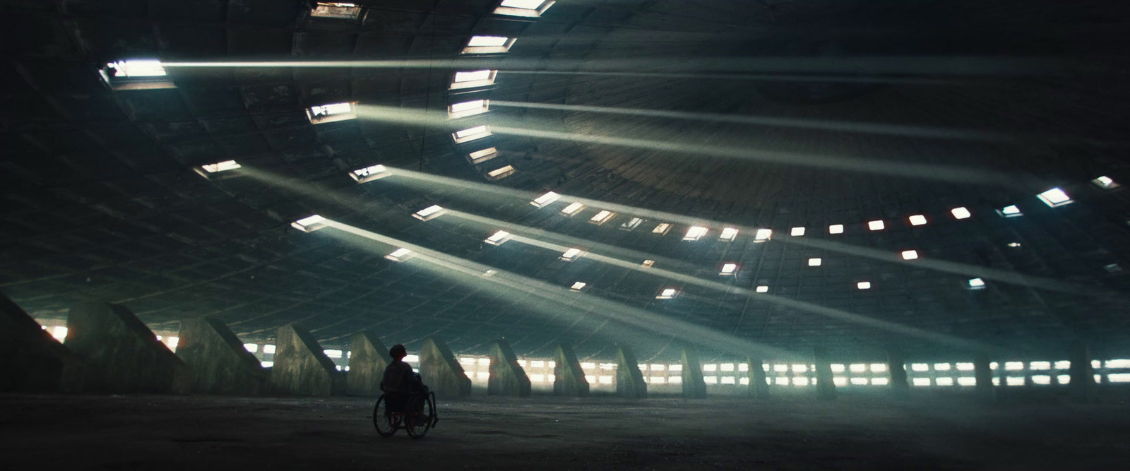 a man riding a bike through a dark tunnel