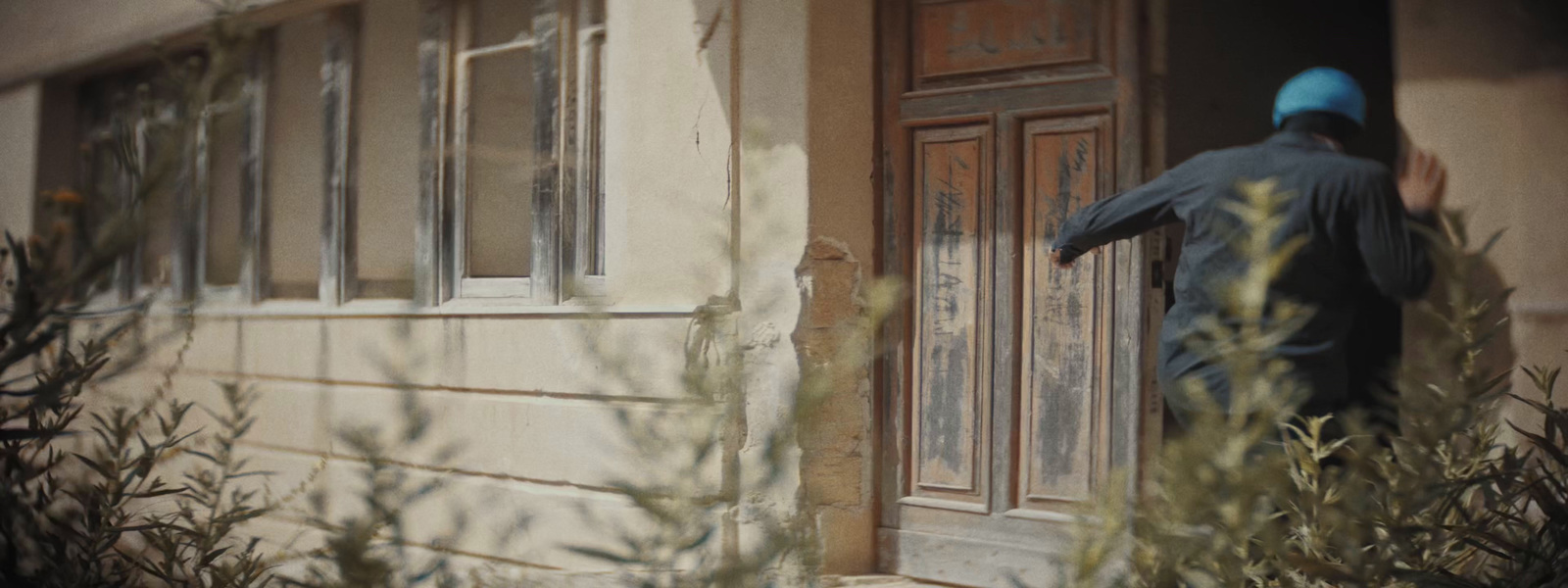 a man standing outside of a door of a building