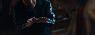 a man standing in front of a book shelf