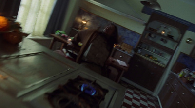 a woman standing in a kitchen next to a stove top oven