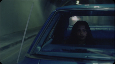 a woman sitting in a car looking out the window