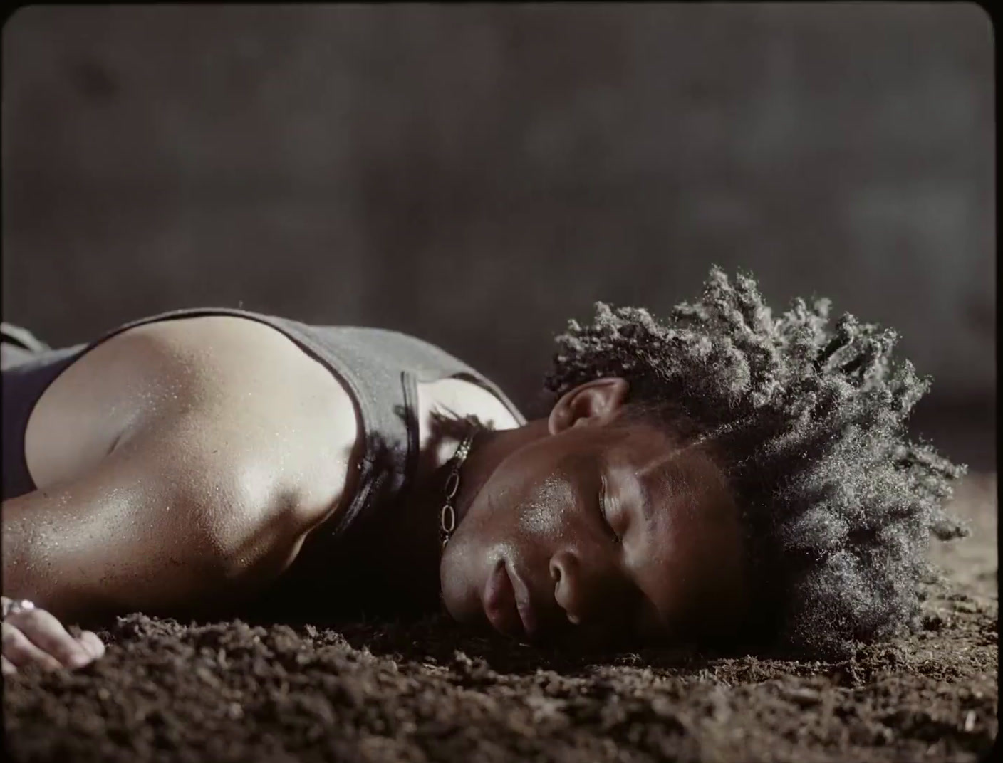 a woman laying on the ground with her eyes closed