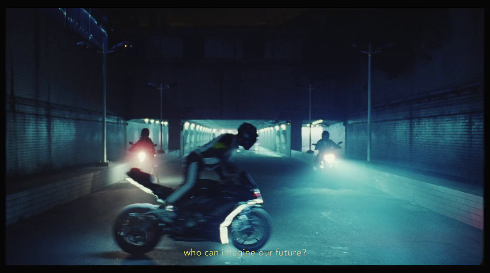 a man riding a motorcycle through a tunnel