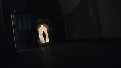 a person standing in a doorway at night