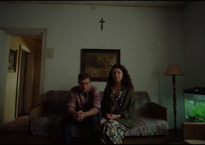 a man and woman sitting on a couch in a living room