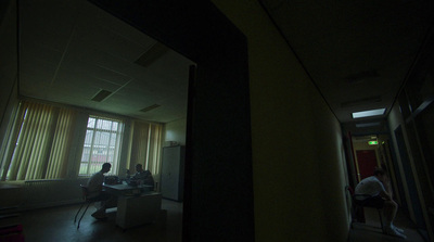 a group of people sitting at a table in a dark room