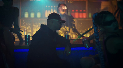 a man sitting at a bar in front of a woman