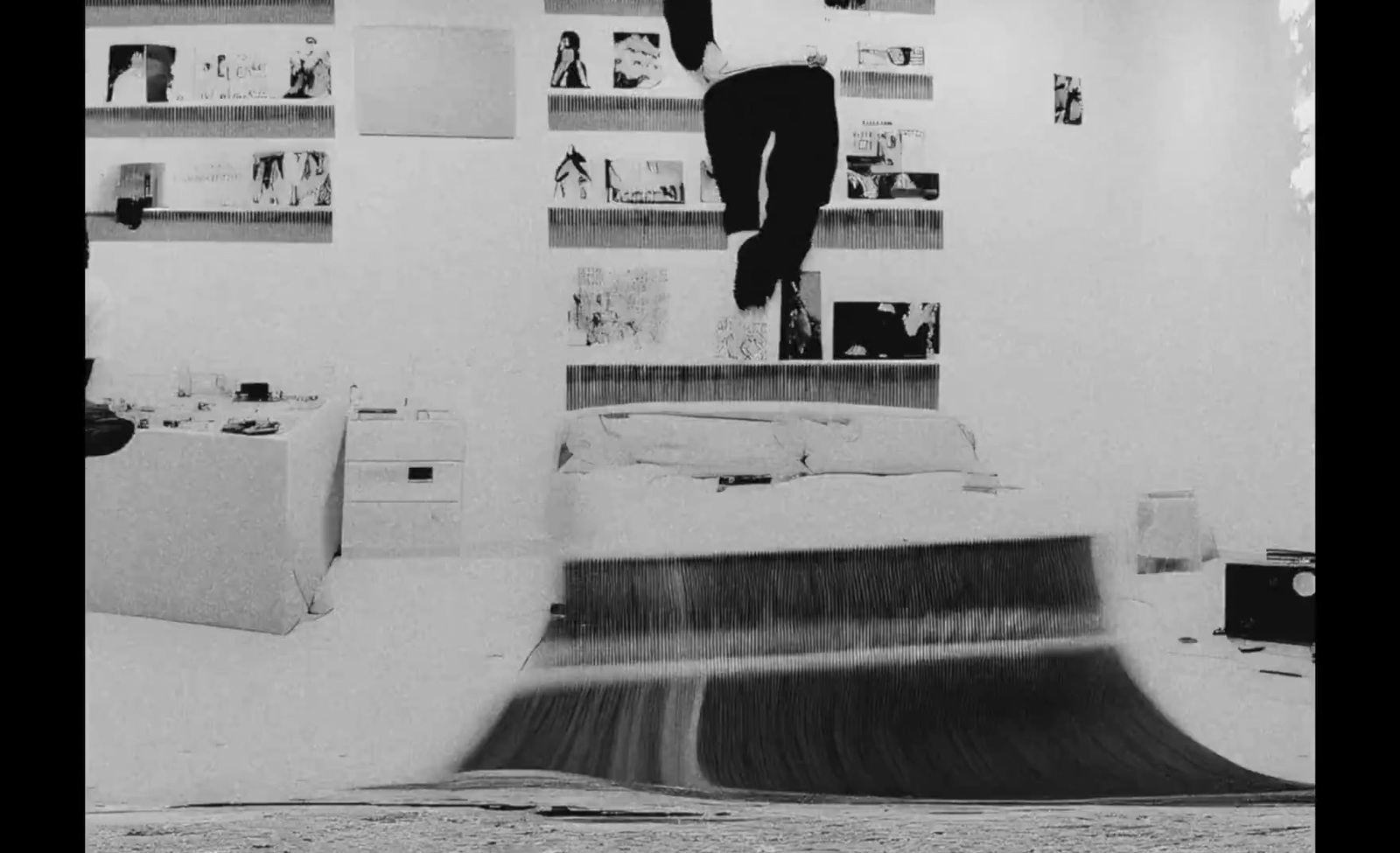 a black and white photo of a person doing a trick on a skateboard