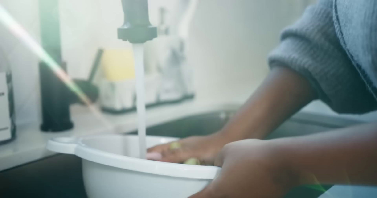 a close up of a person washing their hands in a toilet