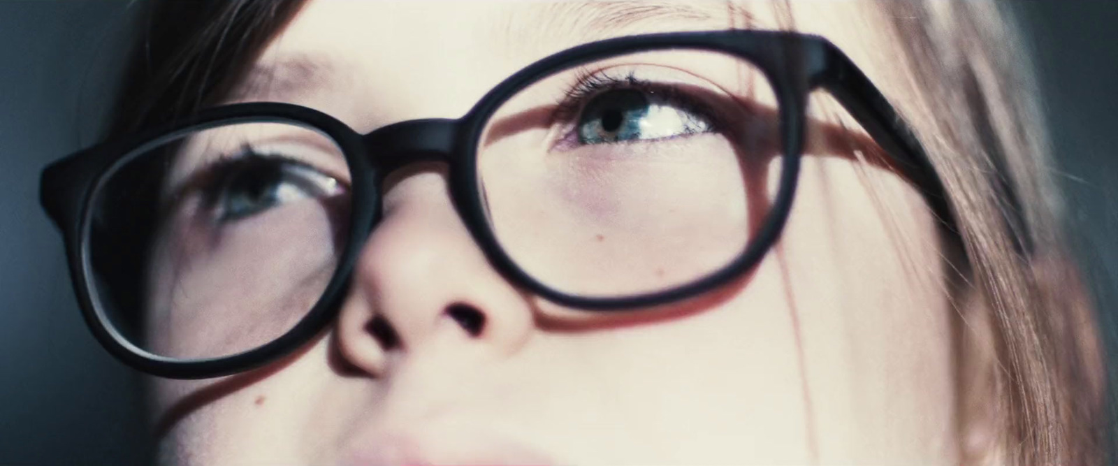 a close up of a person wearing glasses