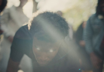 a young man looking down at a cell phone