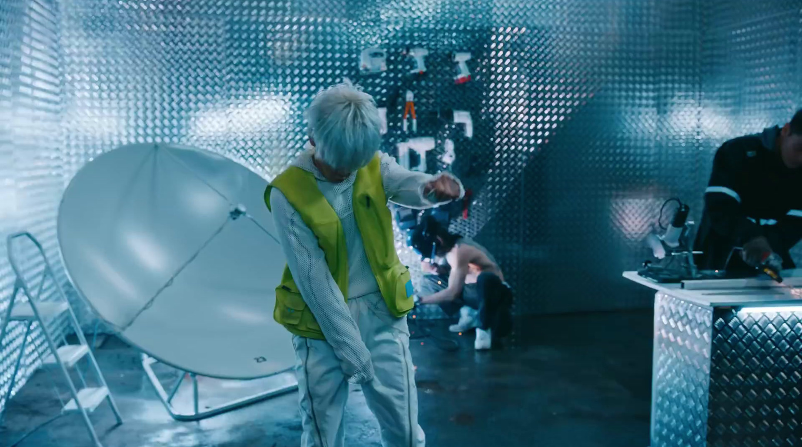 a man standing in front of a satellite dish