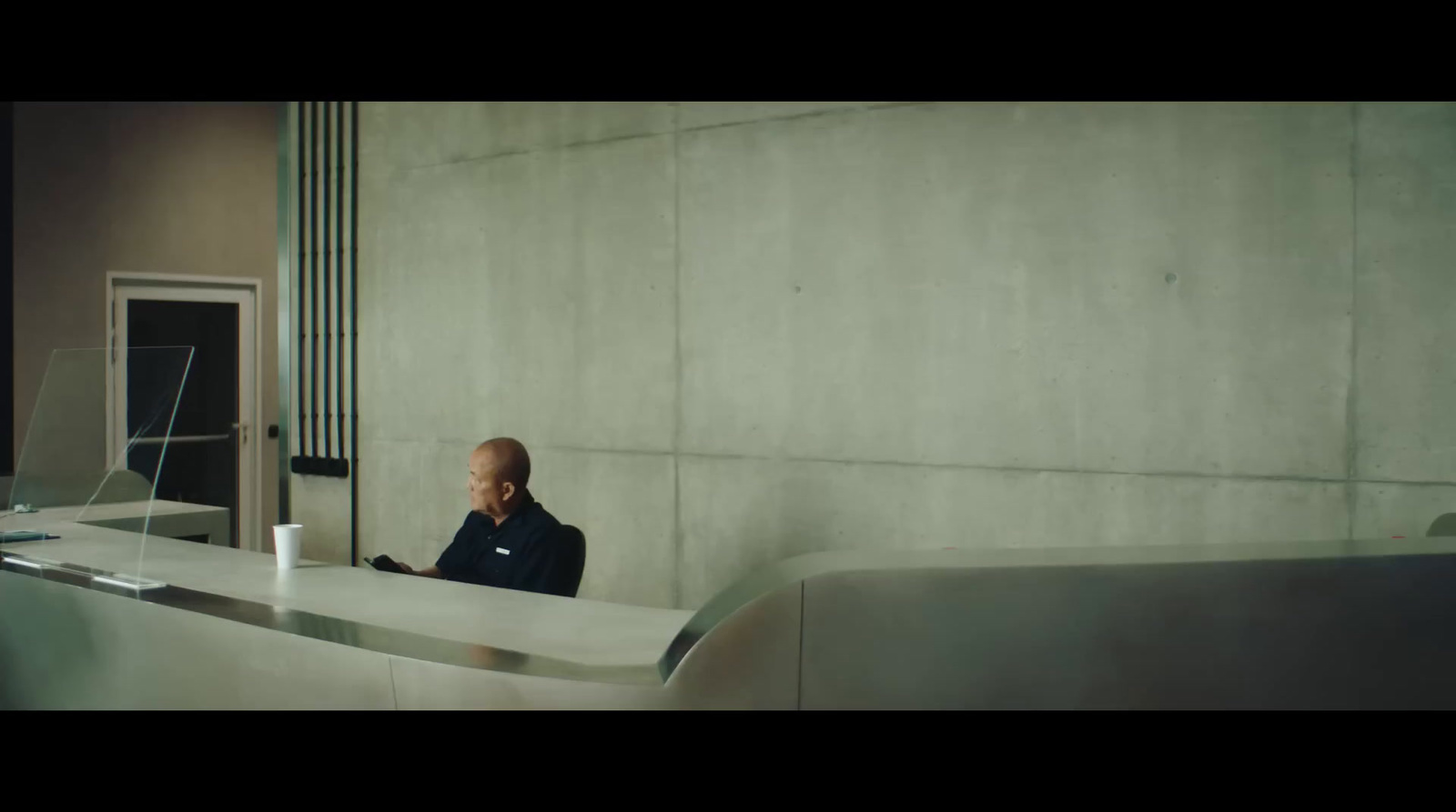 a man sitting at a counter talking on a cell phone