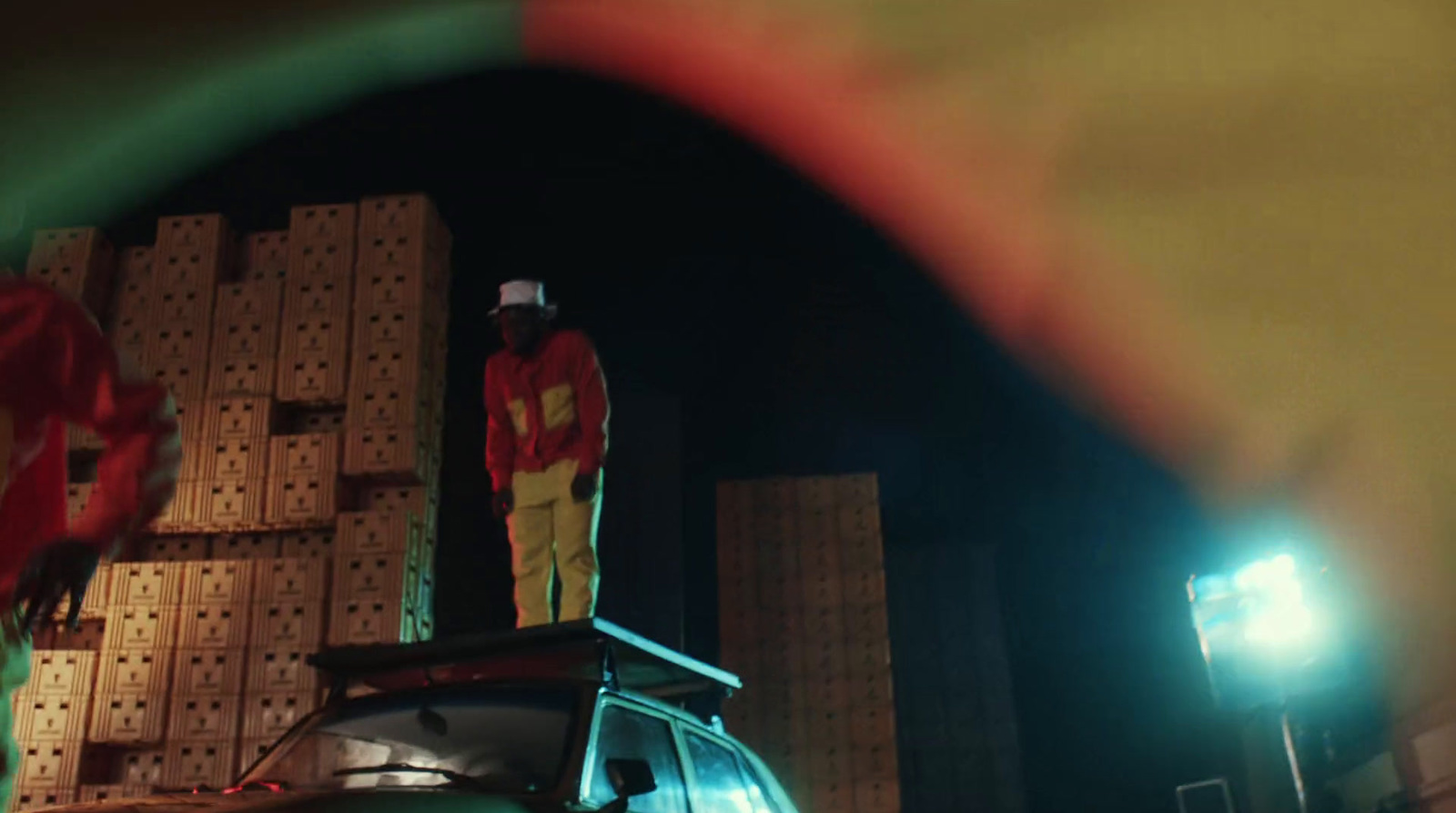 a man standing on top of a truck next to a pile of boxes