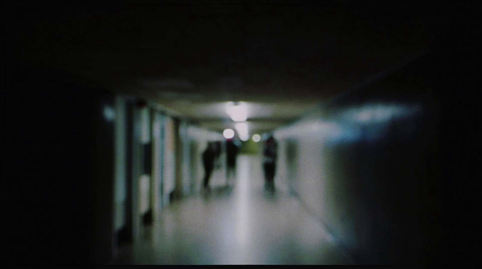 a blurry photo of people walking down a hallway