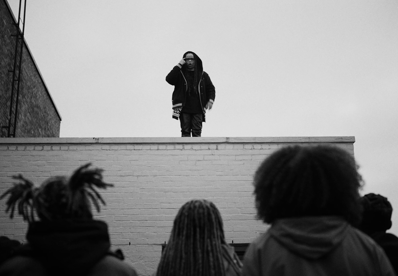 a man standing on top of a brick building