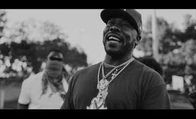 a man wearing a baseball cap and a necklace