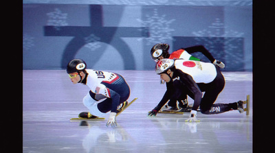 a group of people riding skates on top of a ice rink