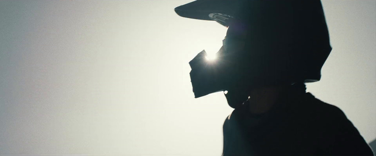 a silhouette of a person wearing a hat